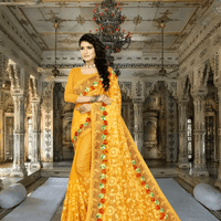 Yellow net saree glowing under palace torches, golden embroidery catching firelight