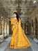 Yellow net saree glowing under palace torches, golden embroidery catching firelight