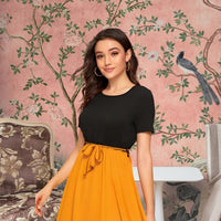 Front view of The Solar Requiem dress with yellow skirt and black top
