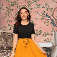 Front view of The Solar Requiem dress with yellow skirt and black top
