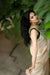 Front view of off-white silk saree in regal room setting