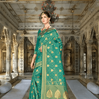 Close-up of gold zari border on green silk saree