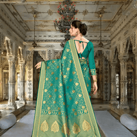 Emerald green Banarasi pallu flowing with zari accents in royal setting