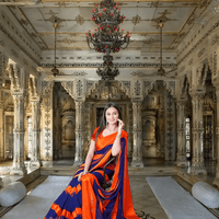 Model seated in orange-navy saree for minimalist wedding