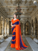 Woman twirling orange-to-navy solid saree in desert sunset