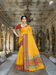 Model draped in yellow Kota Doria saree, golden light catching tri-colored border inside a palace archway