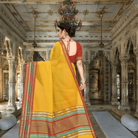 Side pose with the saree flowing mid-step, border shimmering like musical notes in motion