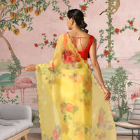 Back view showing the airy drape of the yellow printed saree