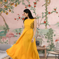  Front view of yellow sleeveless crepe gown in palace backdrop