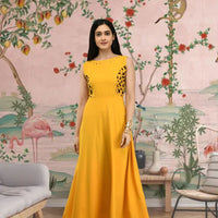  Front view of yellow sleeveless crepe gown in palace backdrop