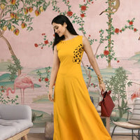 Right angle of yellow crepe gown with floor-length finish