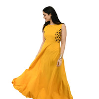 Studio right profile of bright yellow floor-length gown