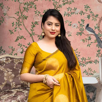  Front view of yellow silk printed saree glowing in regal setting