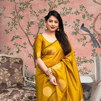  Front view of yellow silk printed saree glowing in regal setting