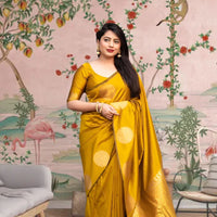 Front view of yellow silk printed saree glowing in regal setting