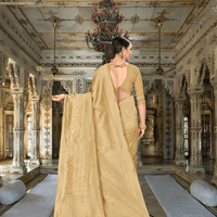 Flowing pallu of golden silk saree with regal interior in background