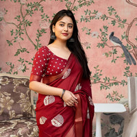  Front view of red cotton crape saree glowing in heritage palace light