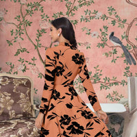 Back view of orange Thaaravesha dress showing elegant fit and length