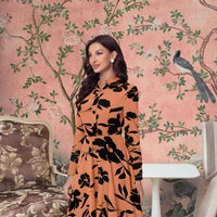 Side angle of orange full sleeve floral bodycon dress