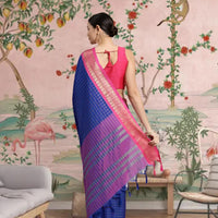 Rear view showcasing deep blue pallu fall with intricate checks