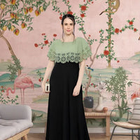  Front view of green-black sleeveless crepe gown in palace setting