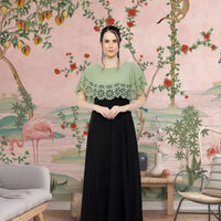  Front view of green-black sleeveless crepe gown in palace setting