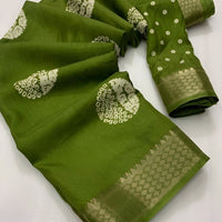 Closeup of green cotton crape fabric print, border, and thread detail