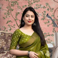 Front view of 💚 Vaidarbhi green cotton crape saree styled in ethnic decor