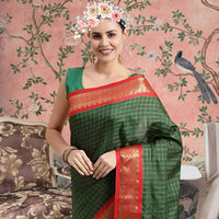 Front view of bottle green cotton silk checkered saree glowing in royal setting