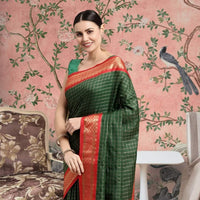 Front view of bottle green cotton silk checkered saree glowing in royal setting