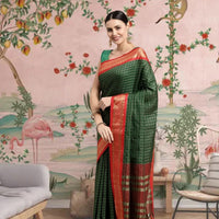  Front view of bottle green cotton silk checkered saree glowing in royal setting