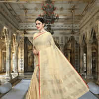 Model standing against sandstone pillar, beige saree catching sunlight like sacred dust