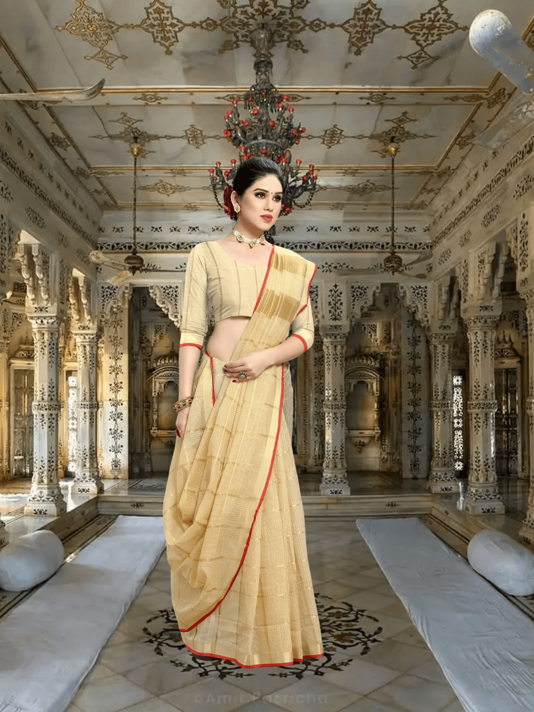 Model standing against sandstone pillar, beige saree catching sunlight like sacred dust