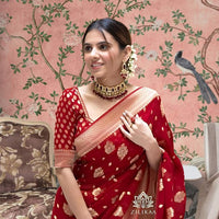 Front view of red Arani Pattu saree glowing in traditional palace setting