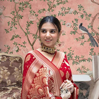 Front view of red Arani Pattu saree glowing in traditional palace setting