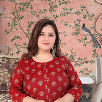 Front view: Maroon kurti against stone corridors at dusk