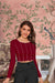  Front view against wine-hued wall—fabric sculpted like dusk