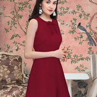Model flaunting the Velvet Reign maroon sleeveless dress in styled background