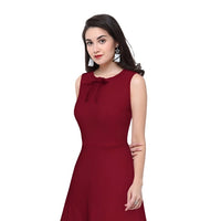 Model showcasing the maroon Velvet Reign dress from Celestina on plain background