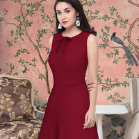 Side angle showing fit and flow of the Velvet Reign maroon polyester dress