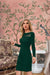 Side shot in stretchable dark green dress – quiet strength and flow