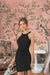Front view of Celestina’s Void Siren black sleeveless knit dress