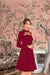Model in deep maroon dress with full sleeves – royal palace room backdrop